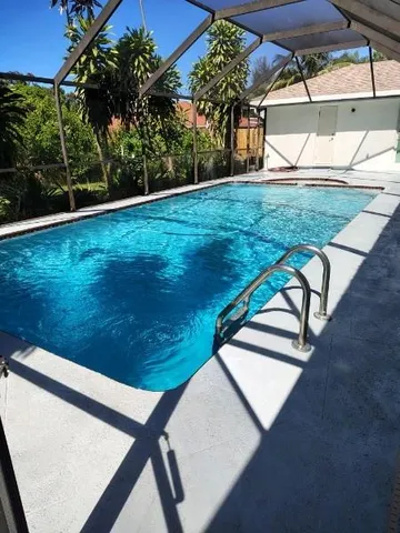 a view of a backyard with table and chairs