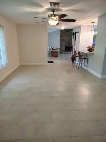 a view of a livingroom with furniture and a ceiling fan