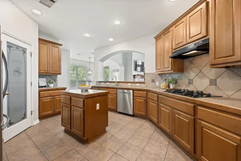 a kitchen with stainless steel appliances granite countertop a sink and cabinets