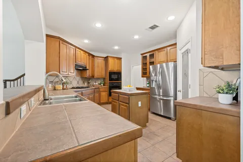 a kitchen with refrigerator cabinets and large window