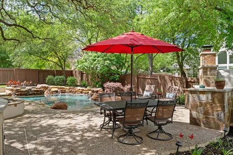 a view of backyard with outdoor seating and trees
