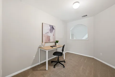 a workspace with furniture and window