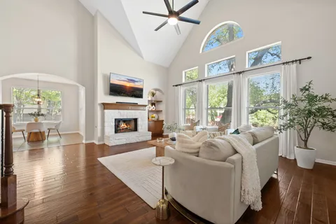 a living room with furniture a fireplace and a flat screen tv
