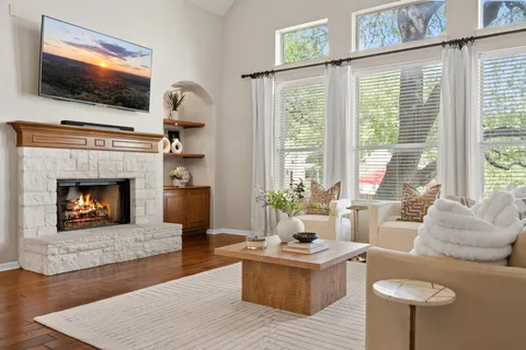 a living room with furniture a flat screen tv and a fireplace