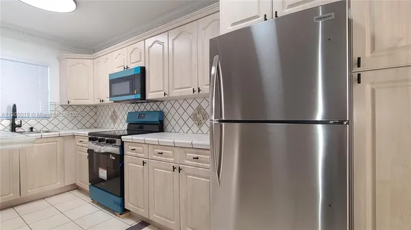a kitchen with a sink stove and cabinets