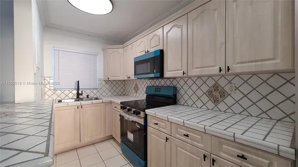 a kitchen with a sink and cabinets