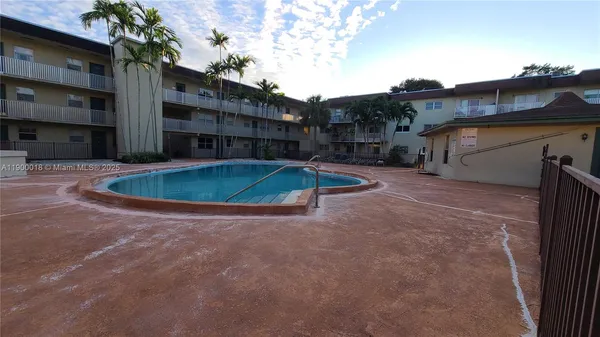 a view of pool with a yard