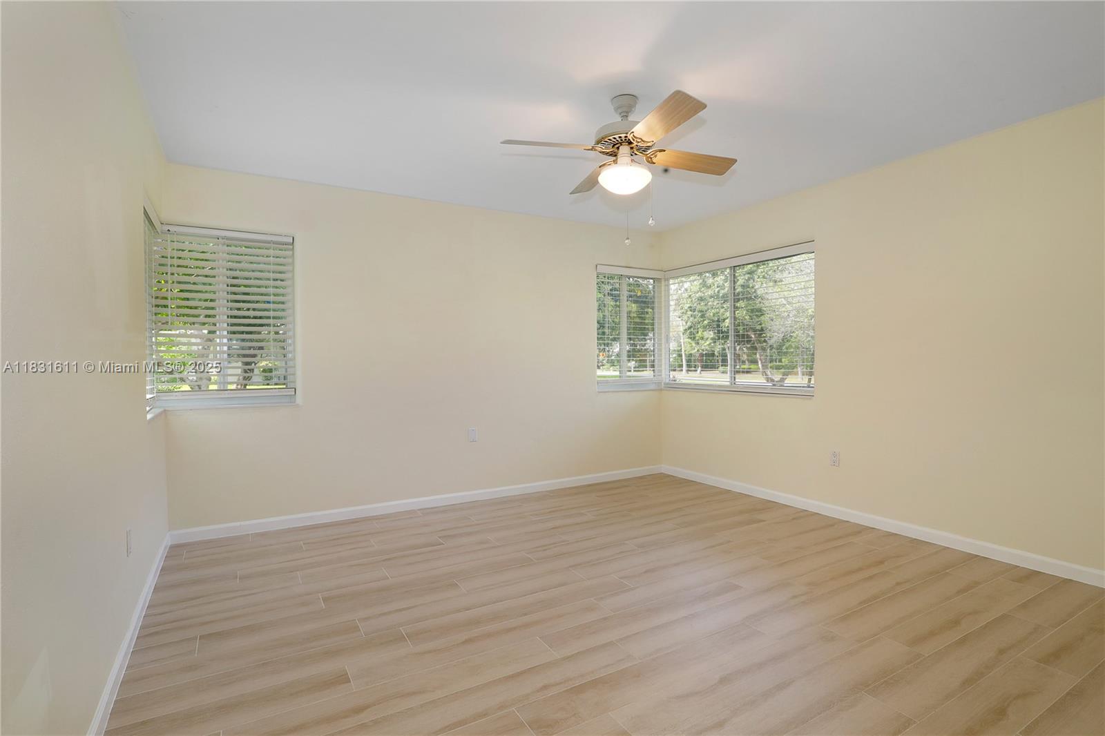 12501 Moss Ranch Road Pinecrest, FL 33156 - Photo 12 of 14 a view of an empty room with wooden floor and a window