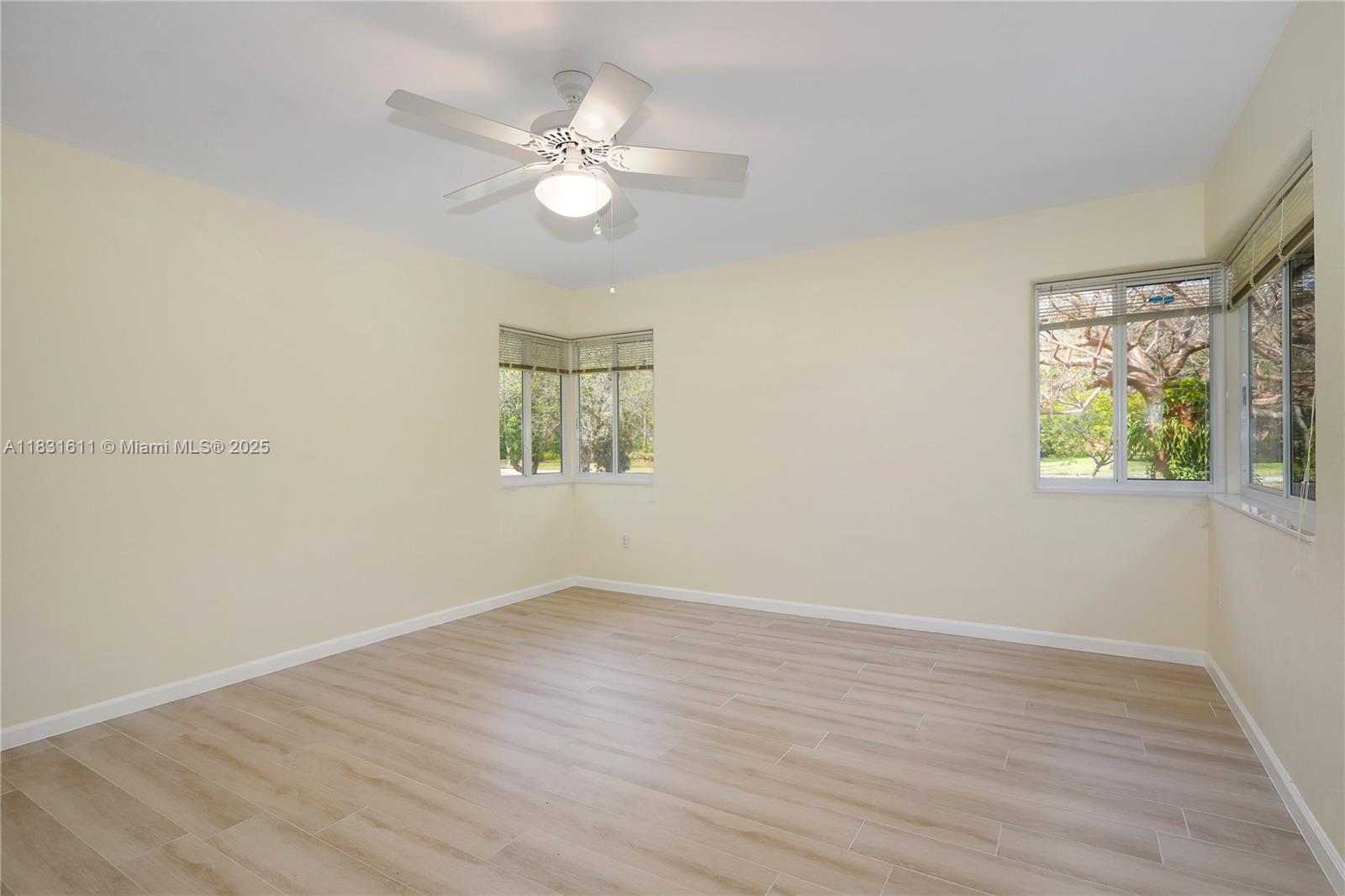 12501 Moss Ranch Road Pinecrest, FL 33156 - Photo 10 of 14 wooden floor in an empty room with a window