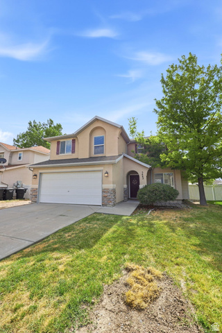 5485 Heather Way Tooele, UT 84074 - Photo 11 of 41 Two-story residence featuring a two-car garage, stone accents, and a covered entry