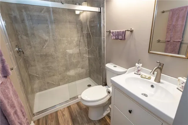 a bathroom with a sink toilet and shower