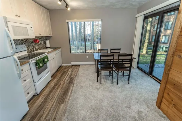 a dining room with furniture and a floor to ceiling window