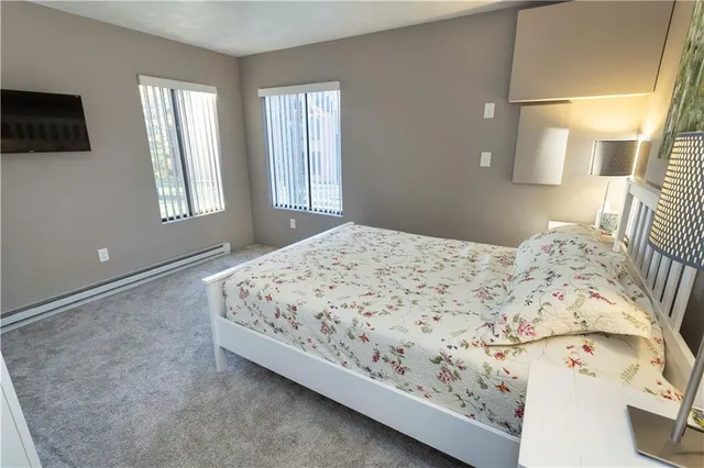 a bedroom with a bed and flat screen tv