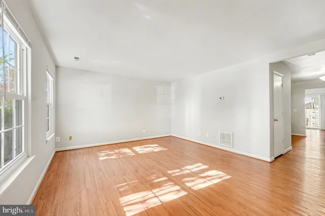a view of an empty room and wooden floor