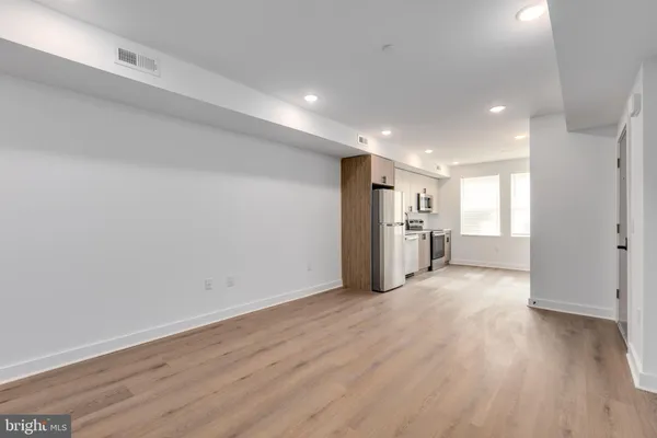 a view of empty room with wooden floor