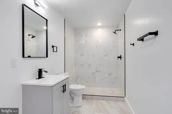 a bathroom with a toilet sink and shower