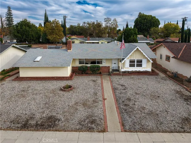 an aerial view of a house with swimming pool and patio
