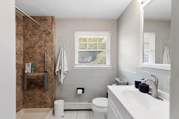 a white toilet sitting next to a bathroom sink