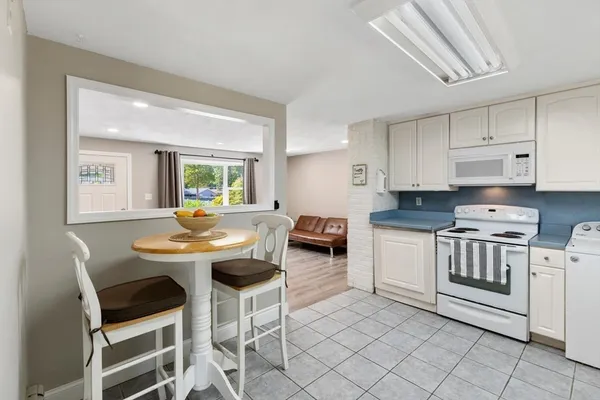 a kitchen with a sink and chairs