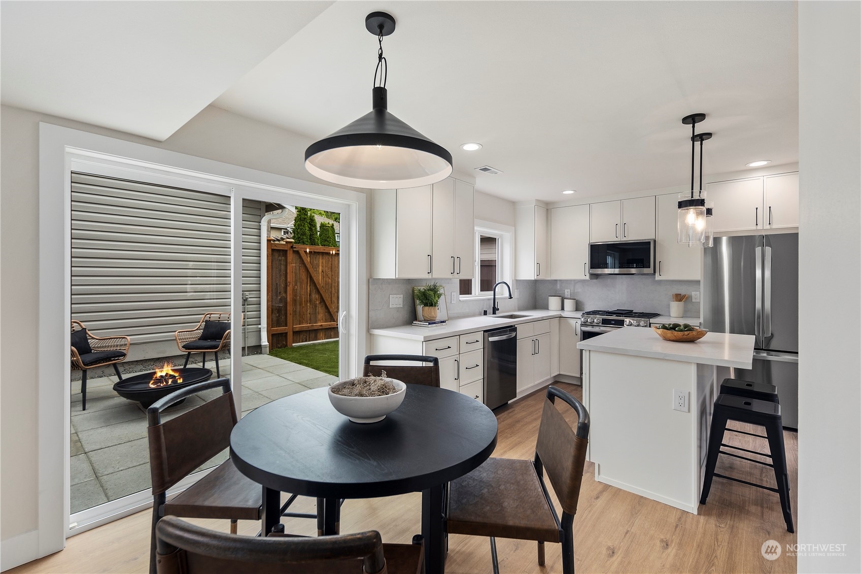 1722 26th Avenue South Seattle, WA 98144 - Photo 12 of 26 a kitchen with a dining table chairs and refrigerator