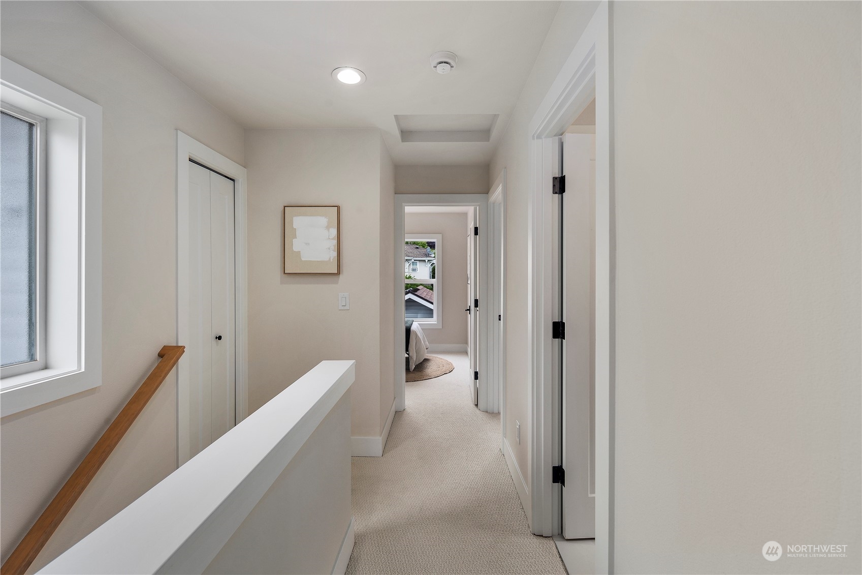 1722 26th Avenue South Seattle, WA 98144 - Photo 21 of 26 a hallway with white doors wooden floor and stairs