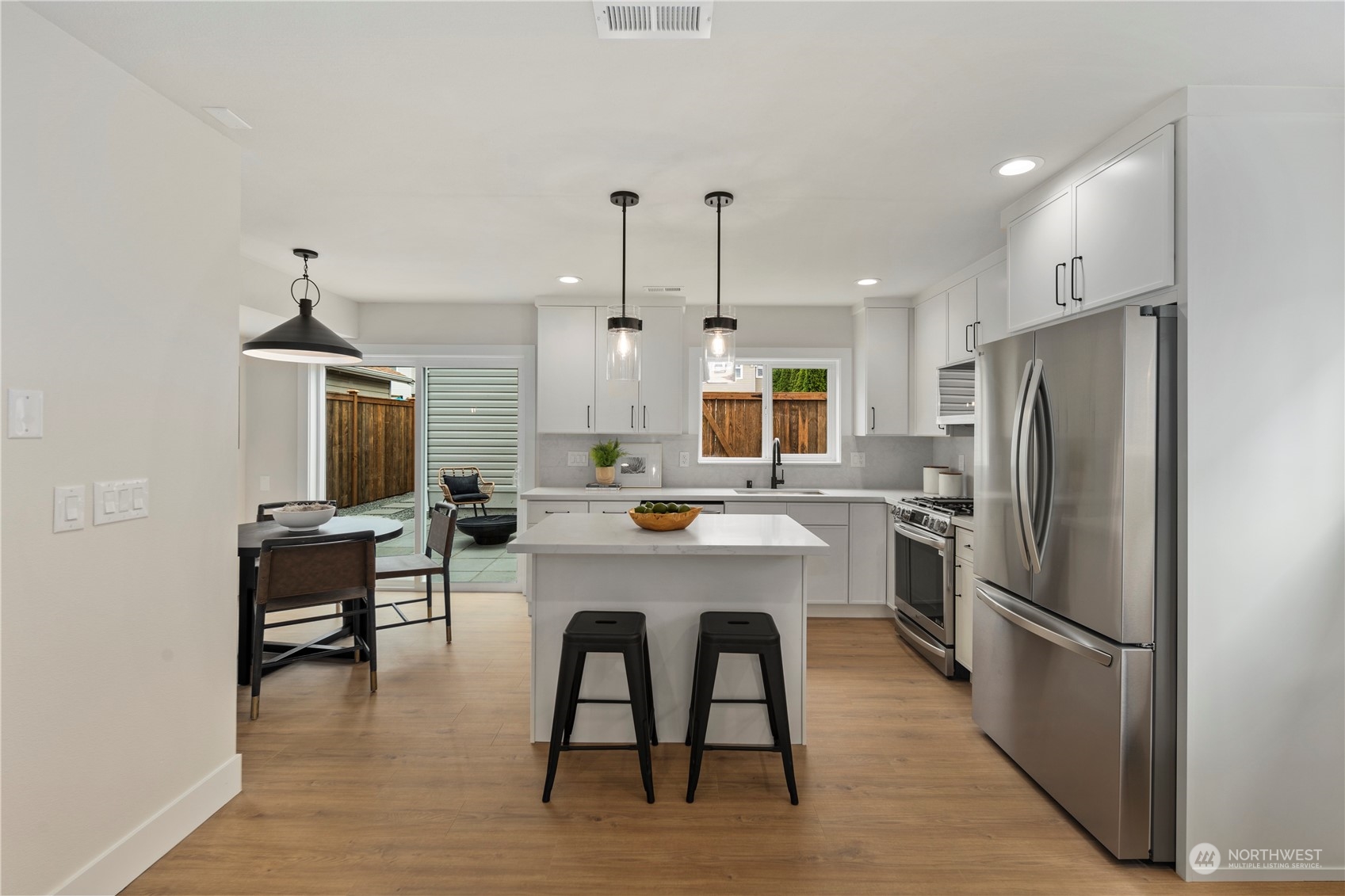 1722 26th Avenue South Seattle, WA 98144 - Photo 8 of 26 a kitchen with stainless steel appliances a refrigerator a stove a dining table and chairs
