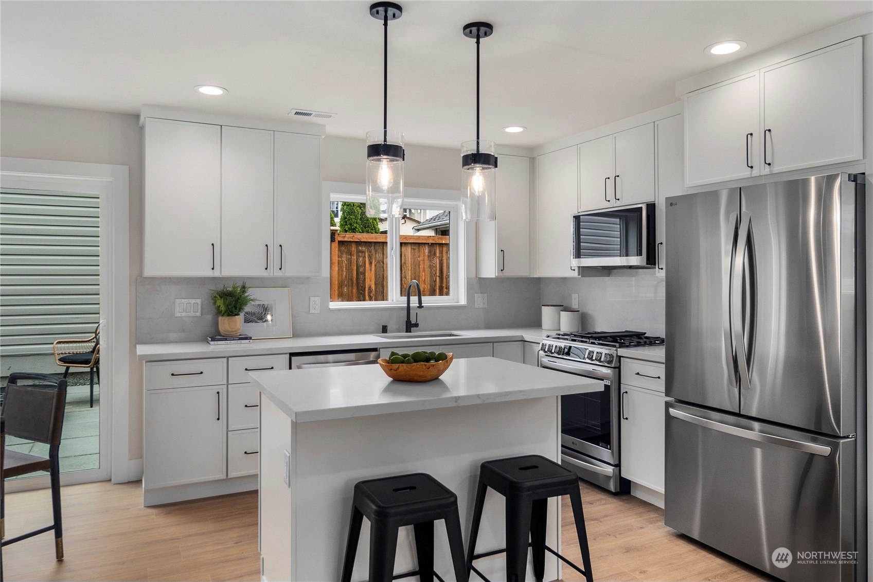 1722 26th Avenue South Seattle, WA 98144 - Photo 10 of 26 a kitchen with stainless steel appliances a stove a sink a refrigerator a center island and a cabinets