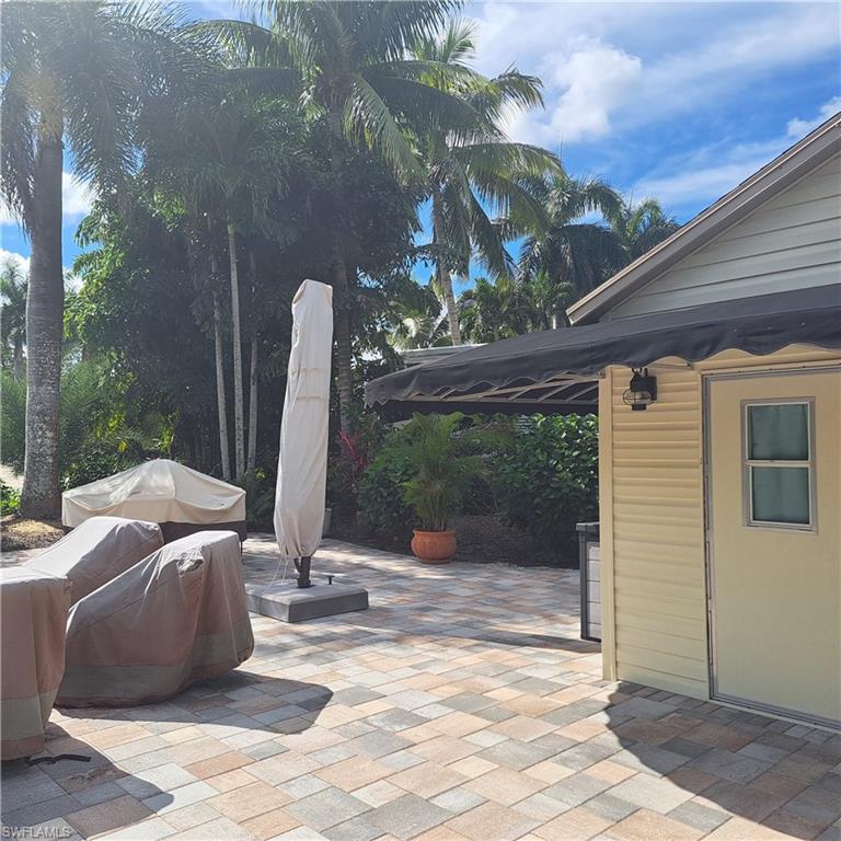 4983 Coach Lane Naples, FL 34114 - Photo 3 of 12 a view of a patio with a table and chairs