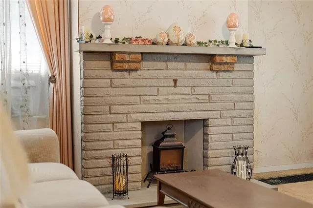 a room with a fireplace and a chandelier