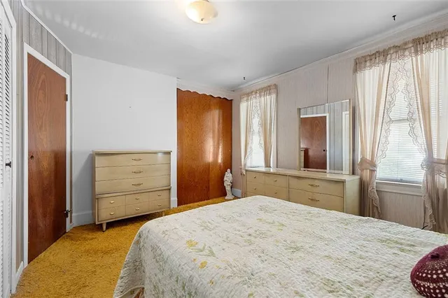 a bedroom with a bed and a dresser