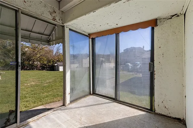 a view of an empty room and bathroom