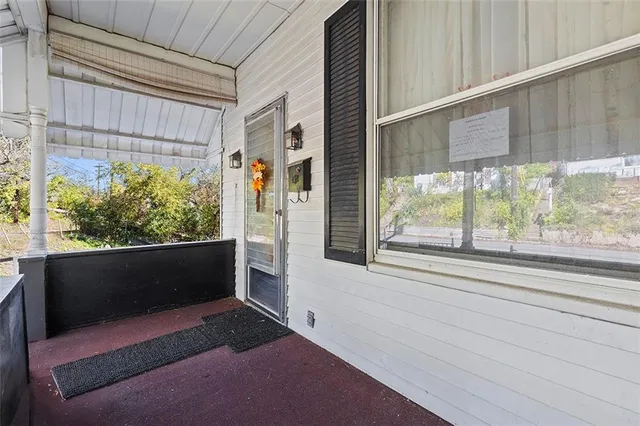 a front view of a house with a large window