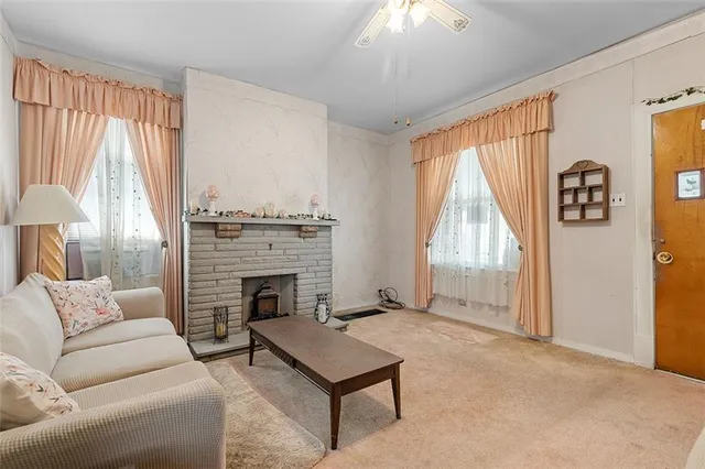 a living room with furniture and a fireplace