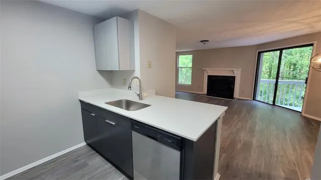 a kitchen with a sink cabinets and a fireplace
