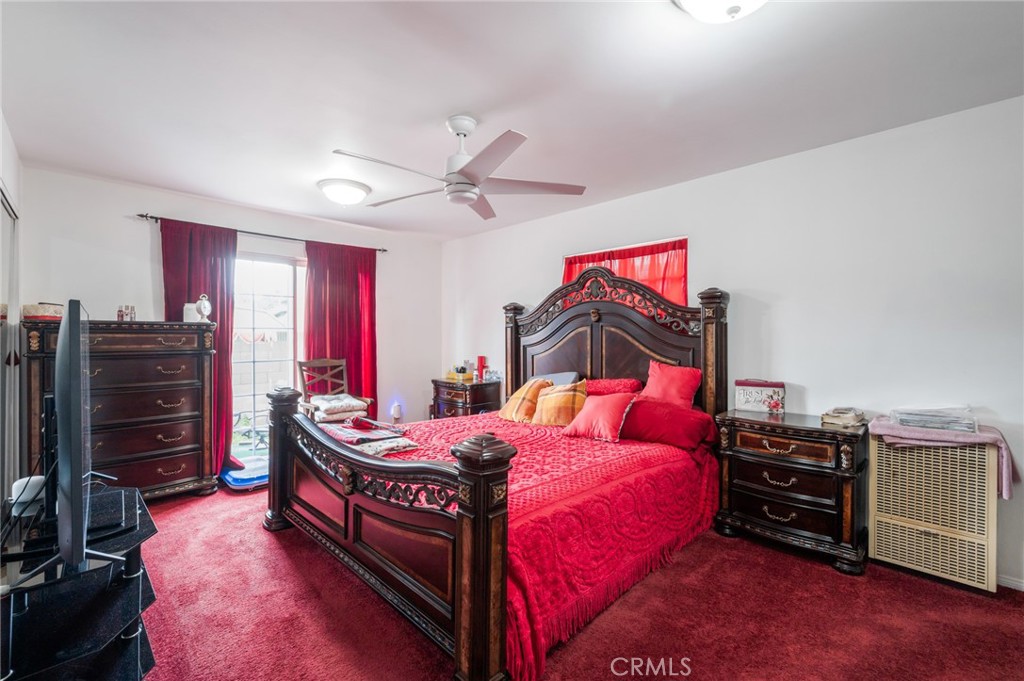 352 East 49th Street Long Beach, CA 90805 - Photo 15 of 23 a bedroom with a bed and a flat tv screen