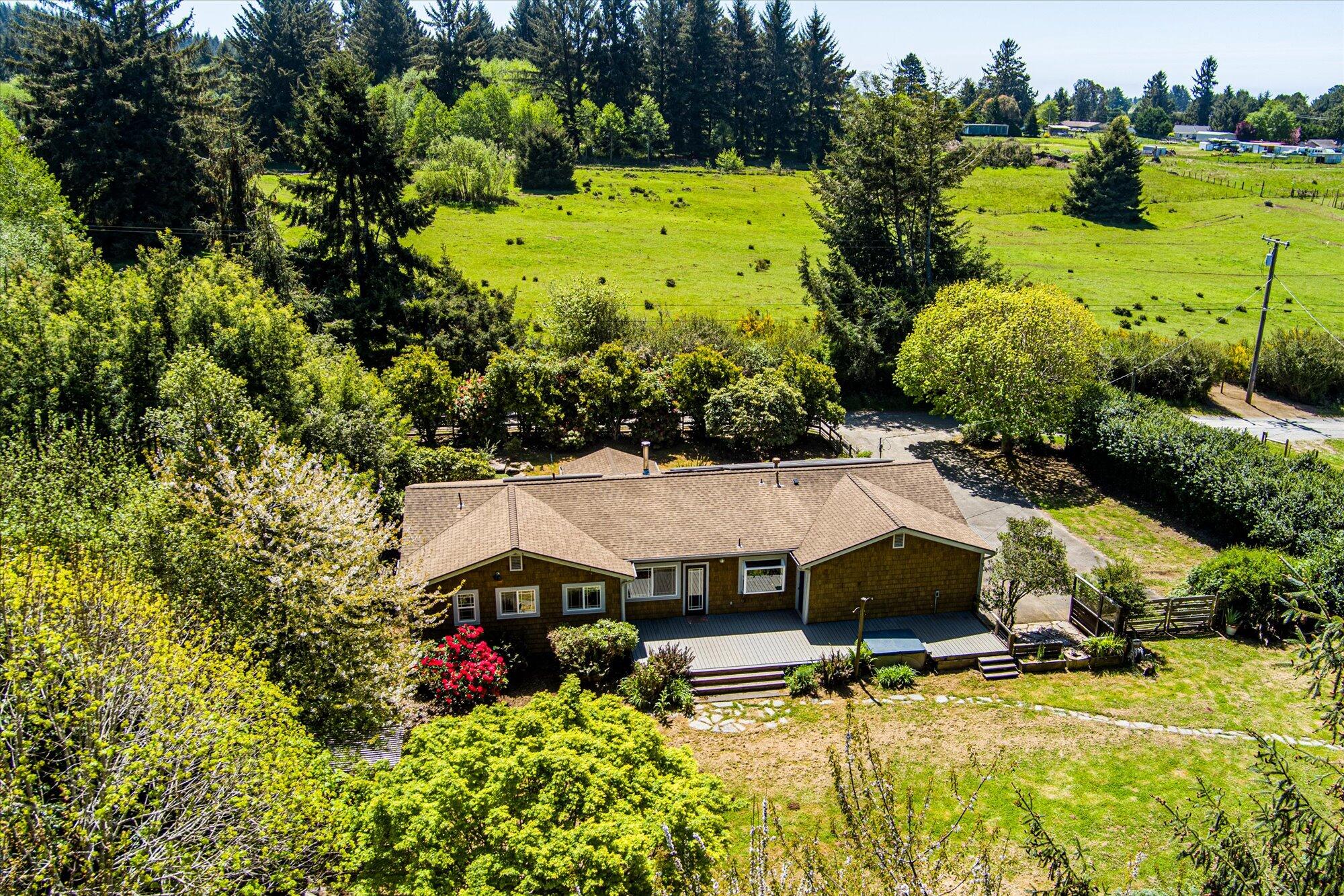 1945 Grange Road McKinleyville, CA 95519 - Photo 3 of 62 a view of a swimming pool with some plants and large trees