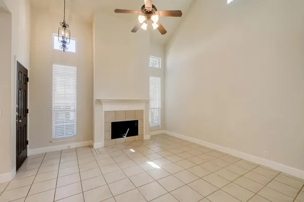 a view of a livingroom with a fireplace window and wooden floor