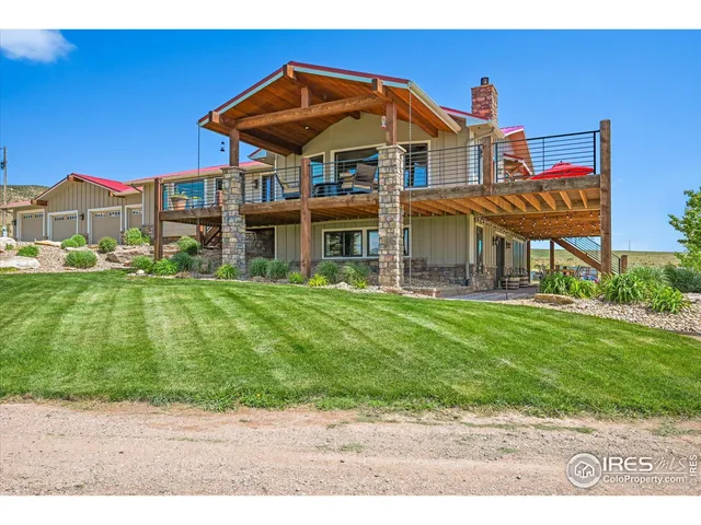 a view of a patio with lawn chairs floor to ceiling window with wooden floor