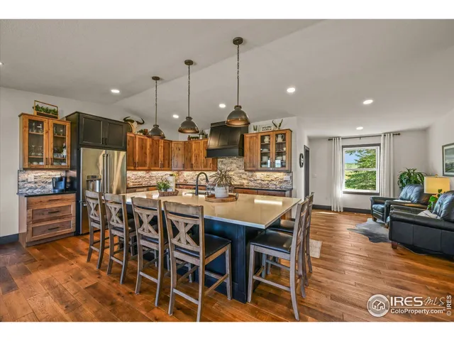 a kitchen with kitchen island granite countertop a sink stove and cabinets
