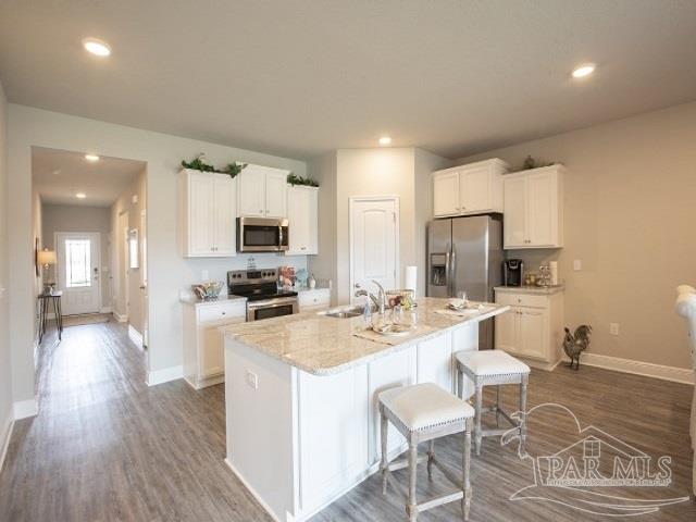 4078 Blaney Lane Pace, FL 32571 - Photo 6 of 31 a kitchen with a sink a counter top space and stainless steel appliances