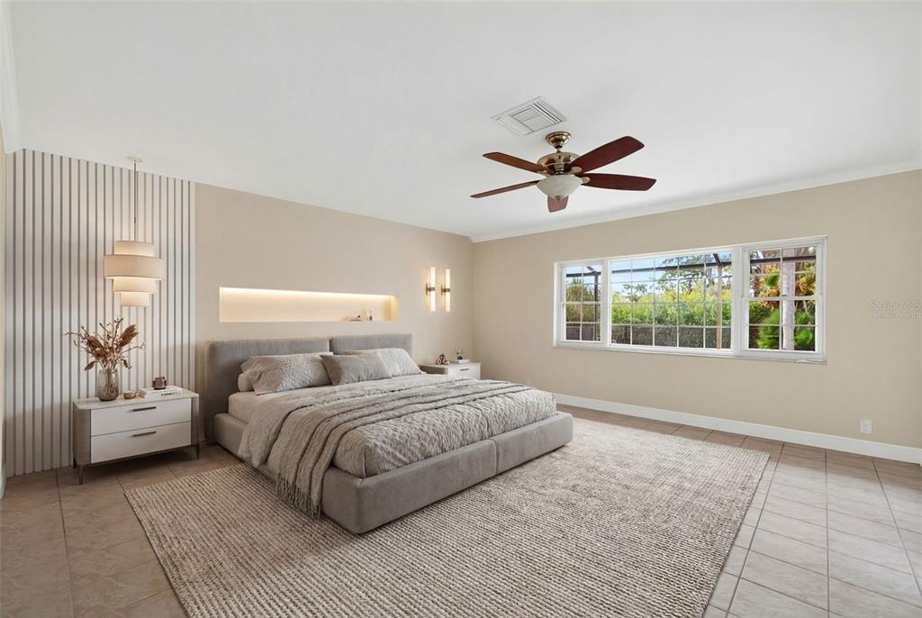 7108 Midnight Pass Road Sarasota, FL 34242 - Photo 19 of 83 a bedroom with a large bed couch and a window