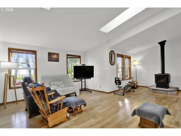 a living room with furniture a flat screen tv and a large window