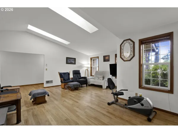 a living room with furniture a window and a clock