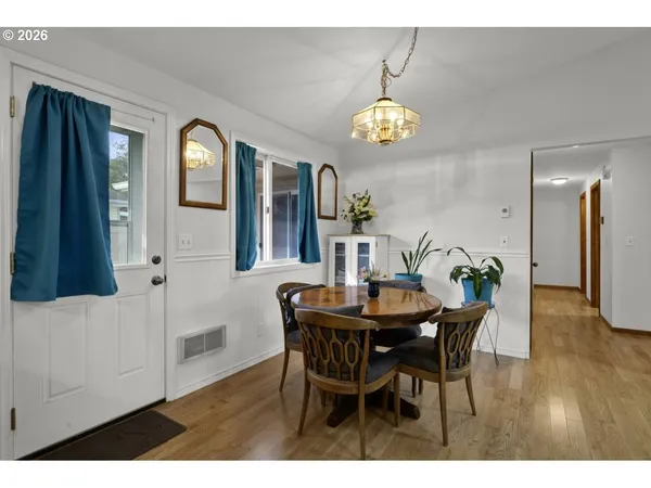 a view of a dining room with furniture and a chandelier