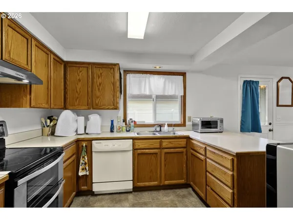 a kitchen with a sink stove and cabinets