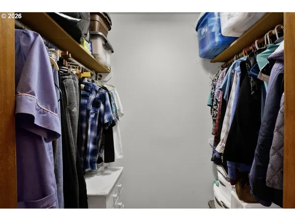 a view of walk in closet with clothes
