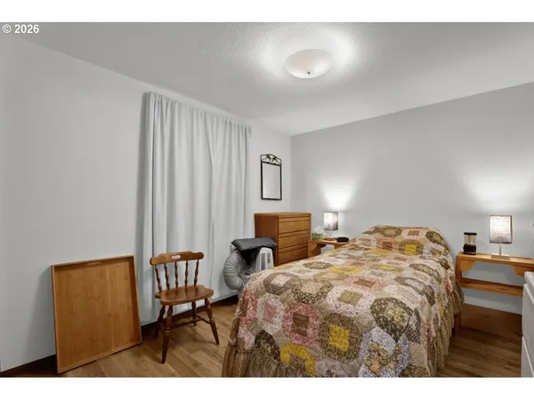 a bedroom with a bed and chair