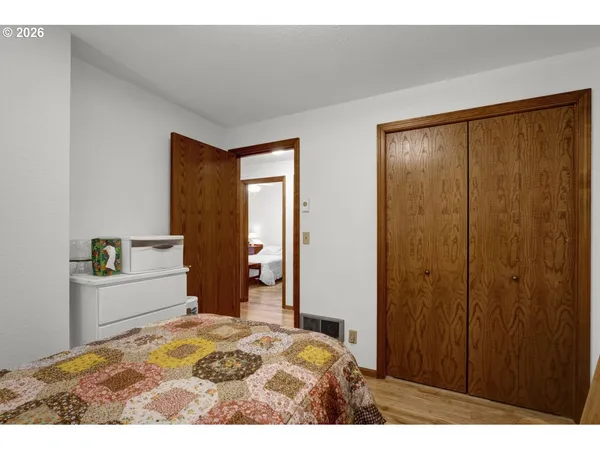 a bedroom with a bed and a dresser