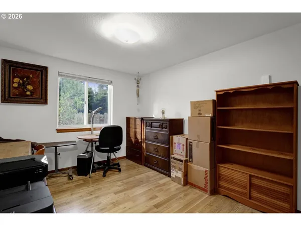 a workspace with furniture hardwood and a window