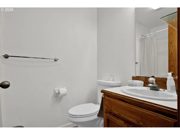 a bathroom with a sink toilet and mirror